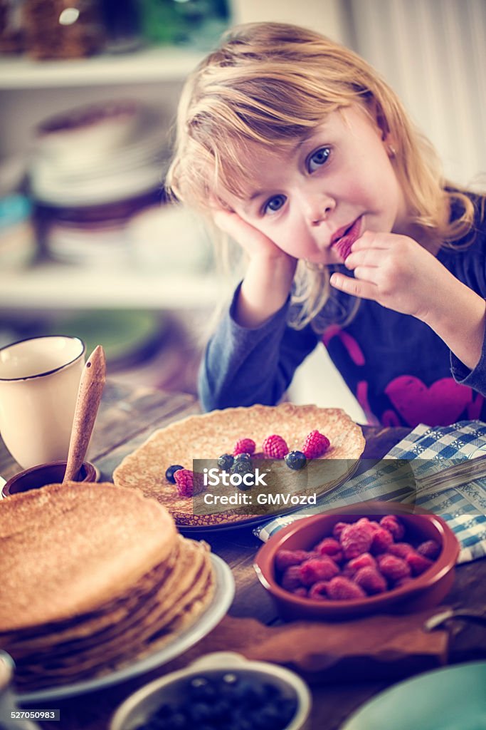 Traditional Dutch Pancakes - Pannenkoeken CNEUFOO595 Cute little girl eating homemade traditional dutch pannenkoeken (pancakes) with fresh berries. CNEUFOO595 4-5 Years Stock Photo