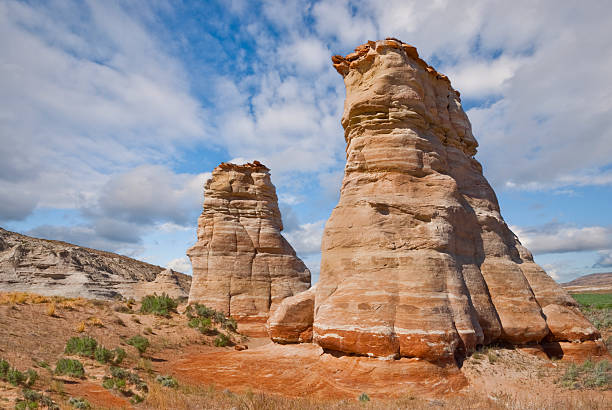 The American Southwest has some amazing landscapes, especially the colorful rock formations. The background of blue sky and puffy clouds adds color, depth and contrast to the scene. This rock formation, known as Elephant's Feet stands alongside State Route 160 near the town of Tonalea, Arizona, USA.