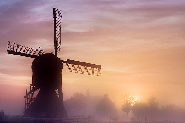 istock Old wooden windmil at sunrise 527052693