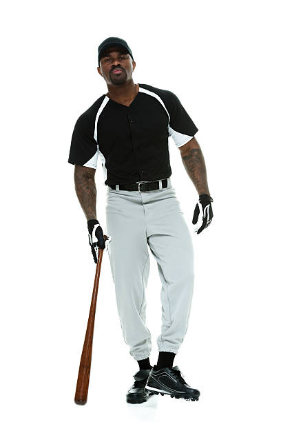 istock Male baseball player standing with bat 527052919