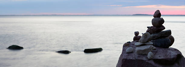 istock Balancing Stones on Beach with Huge Boulders at Sunset 527053658