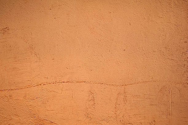 istock Texture of old wall covered with pink stucco 527054355