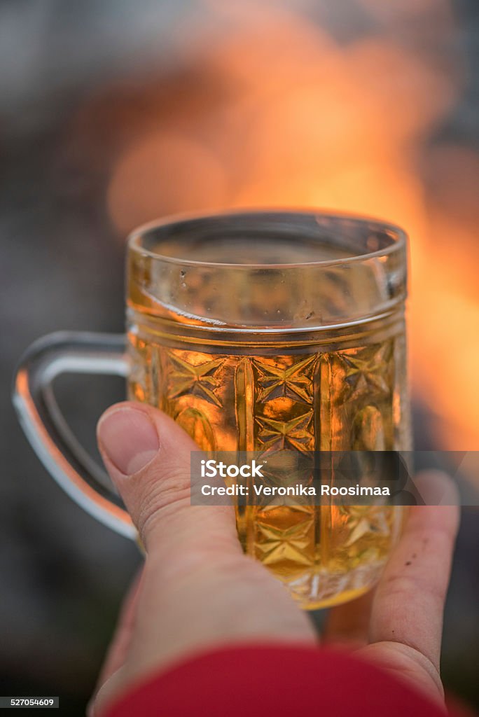 Mulled cider mulled cider in hand with fire on background Christmas Stock Photo