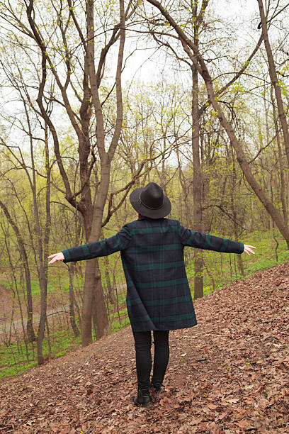 istock Woman in black hat and square print coat, freedom concept 527054902