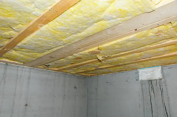 Wet faulty ceiling insulation in a basement.