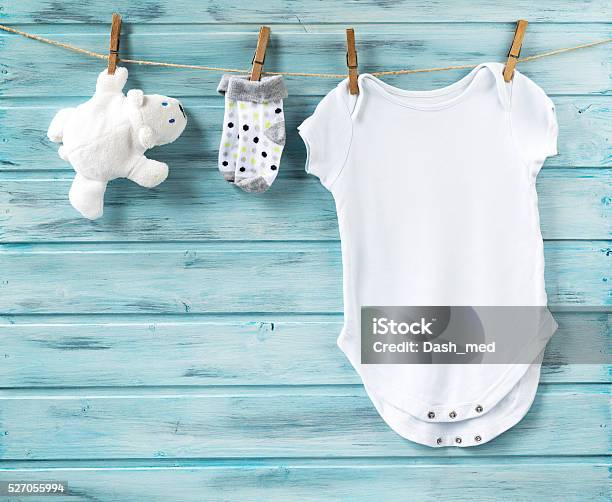 Baby Boy Clothes And White Bear Toy On A Clothesline Stock Photo - Download Image Now
