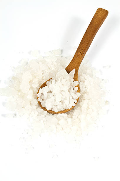 Sea salt crystals Sea salt crystals in clay pot with a wooden spoon sodium intake stock pictures, royalty-free photos & images