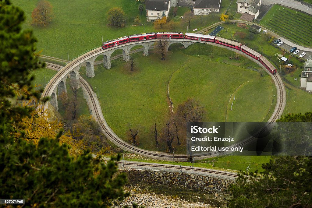 Brusio spiral viaduct Brusio, Switzerland, November, 9, 2014 : A train climbs the famous Brusio spiral viaduct Train - Vehicle Stock Photo