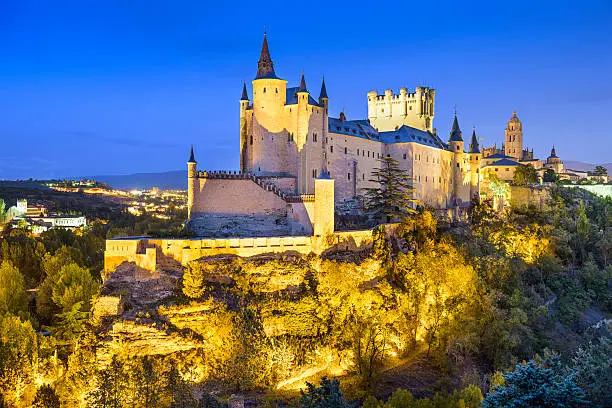 Segovia, Spain town skyline with the Alcazar at night.