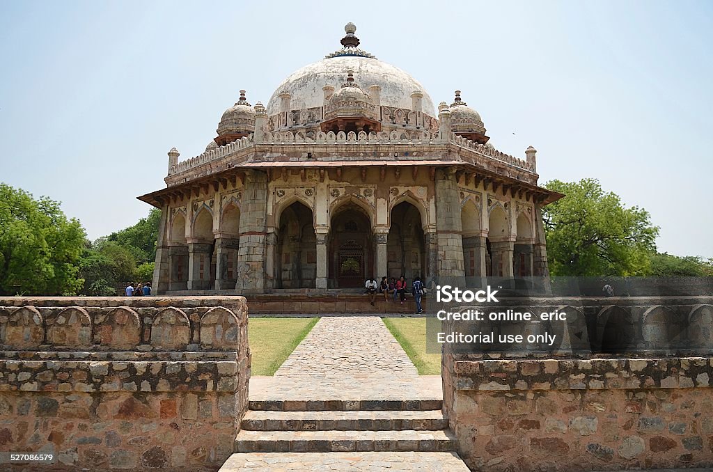 Isa Khan Niyazi's Tomb in Delhi, India Delhi, India - Apr 27 2014: Isa Khan's Tomb, it is in the Humayun's Tomb garden just next to Humayun's Tomb. Tourists are sightseeing for the beautiful windows and building in islamic style, and taking rest next to to tomb. Ancient Stock Photo