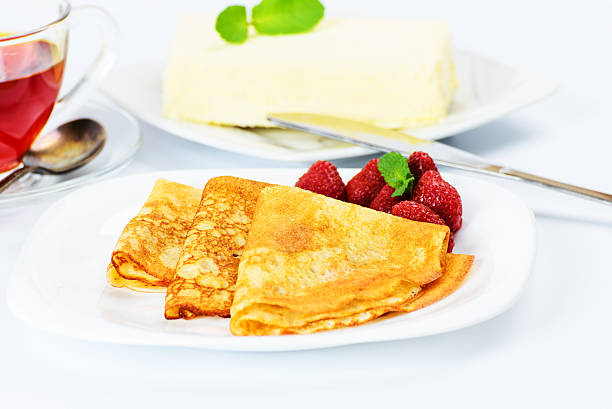 istock Russian pancakes with black tea and strawberries. 527086659