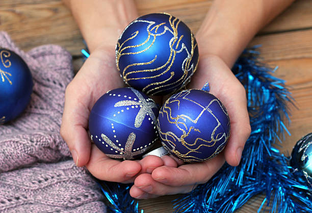 istock Man hands holding christmas balls 527086963
