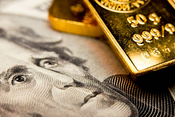 Banknote and a gold bullion Close-up of a 20-dollar banknote (figuring president Jackson) and a gold bullion metal ore stock pictures, royalty-free photos & images