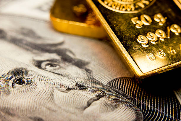 Banknote and a gold bullion Close-up of a 20-dollar banknote (figuring president Jackson) and a gold bullion precious metals stock pictures, royalty-free photos & images