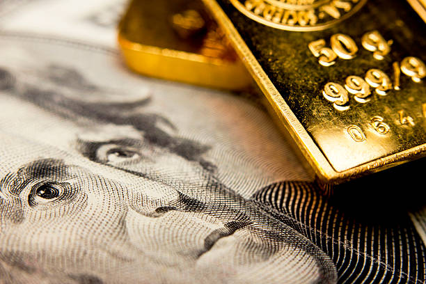 Banknote and a gold bullion Close-up of a 20-dollar banknote (figuring president Jackson) and a gold bullion ounce stock pictures, royalty-free photos & images