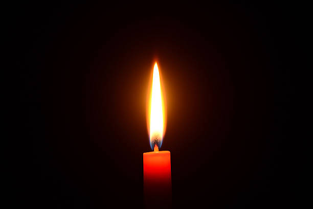 istock Red candle burning on a black background 527088807