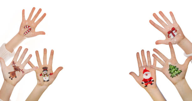 istock Kid's hands with painted Christmas symbol 527088855