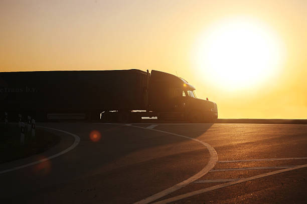 istock truck goes on highway on sunset 527088937