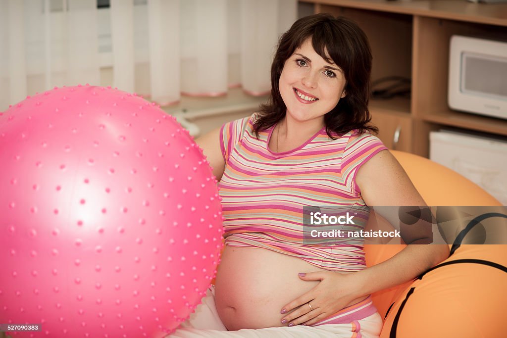 Pregnant woman with gymnastic ball. Pregnant woman with gymnastic ball in a gym. Adult Stock Photo