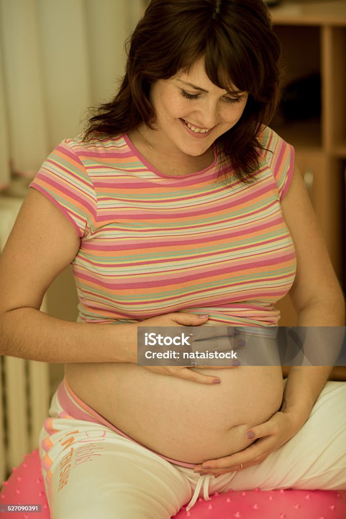 Pregnant woman with gymnastic ball. Pregnant woman with gymnastic ball in a gym. Adult Stock Photo