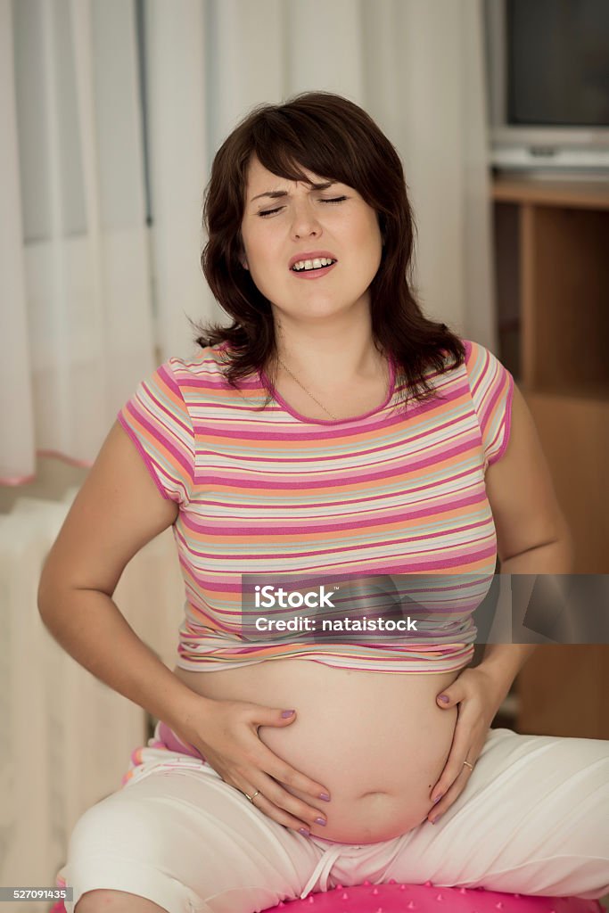 Pregnant woman with gymnastic ball. Pregnant woman with gymnastic ball in a gym. Abdomen Stock Photo