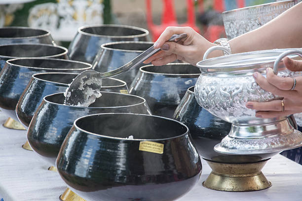 istock puts food offerings in a Buddhist monk's alms bowl 527091655