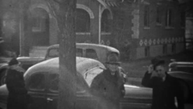 1939: New 2 door coupe style classic car driving residential street.