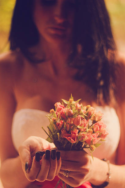 istock young woman holding flowers 527092469