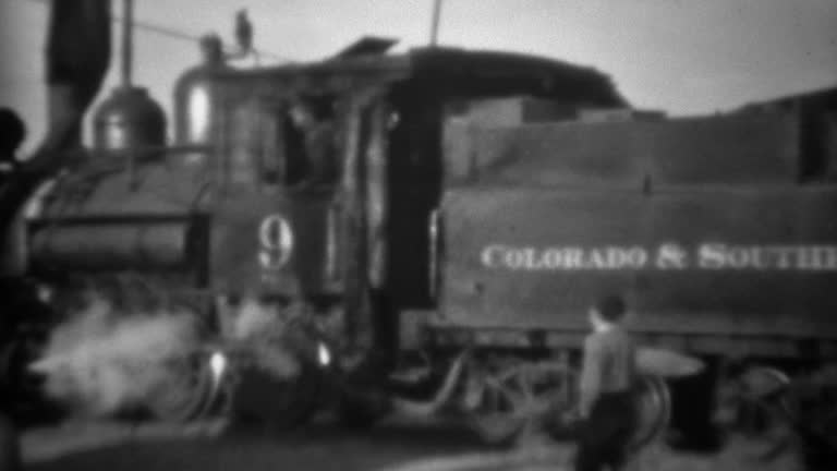 1936: Colorado southern railroad pulling away from train station.