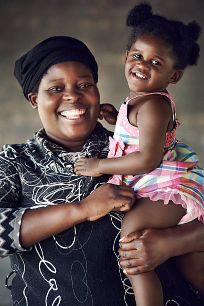 Rural African mother and baby girl smiling and having fun together