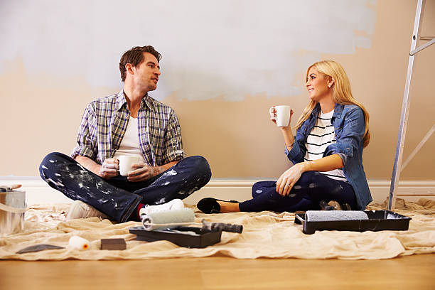 istock Expectant Couple Taking A Break Whilst Decorating Nursery 527114147
