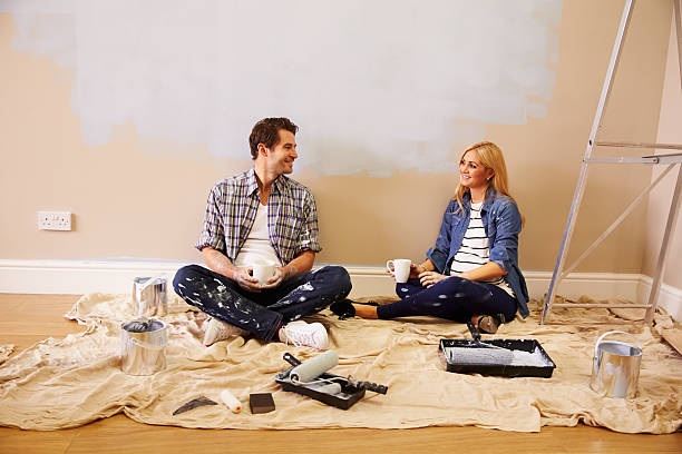 istock Expectant Couple Taking A Break Whilst Decorating Nursery 527114159