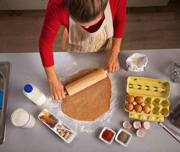 istock young housewife rolling dough in kitchen 527115849