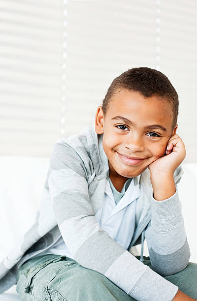 istock Cute African American boy smiling while at home 527116745
