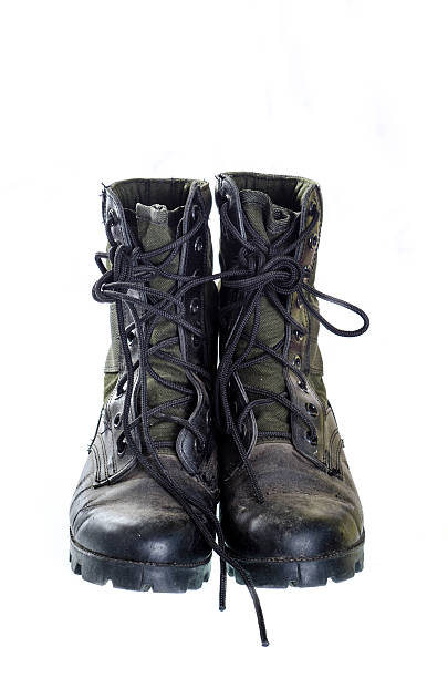 istock Old and dusty combat boots isolated on white. 527117289