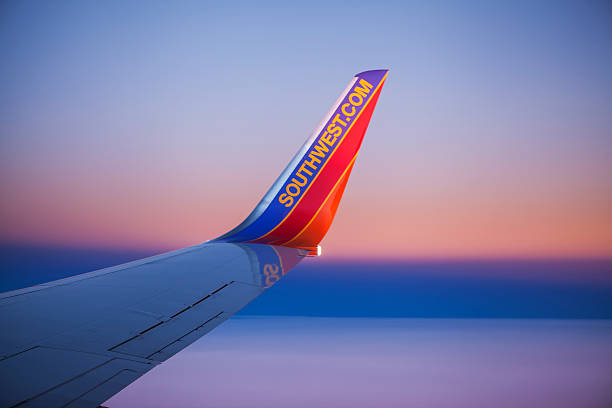 Southwest Airlines Boeing 737 Winglet against Sunset Sky Orlando, Florida, USA - December 2, 2013: A curved winglet with the Southwest.com web site address on the wing of a Boeing 737 airplane operated by Southwest Airlines. boeing 737 photos stock pictures, royalty-free photos & images