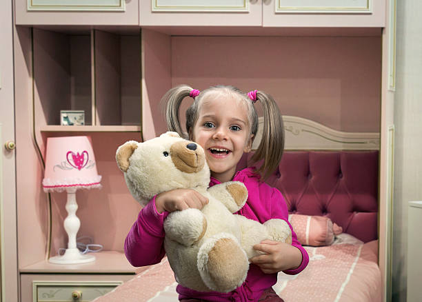 istock Small, funny girl  with toy beart 527117917