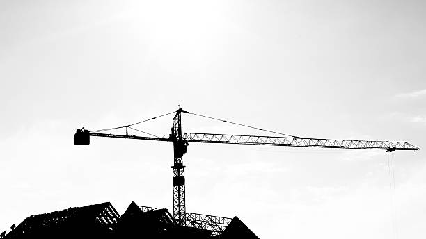 istock Silhouettes of tower crane at construction side 527118033
