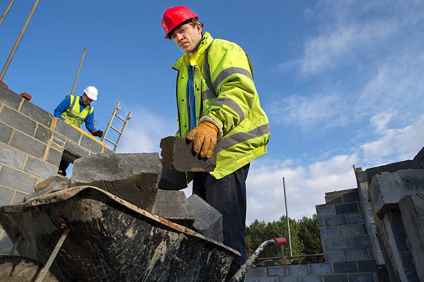 istock Builder with a Wheel Barrow of Bricks 527118139