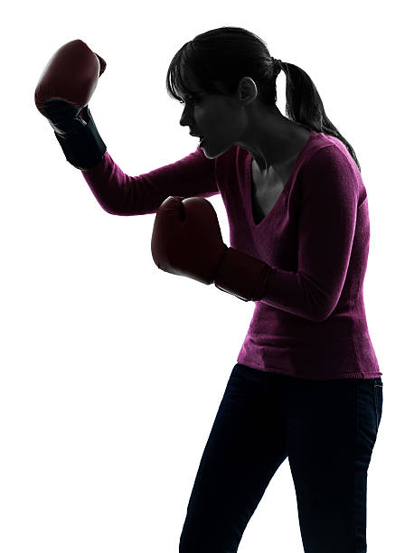 istock mature woman with boxing gloves silhouette 527119059