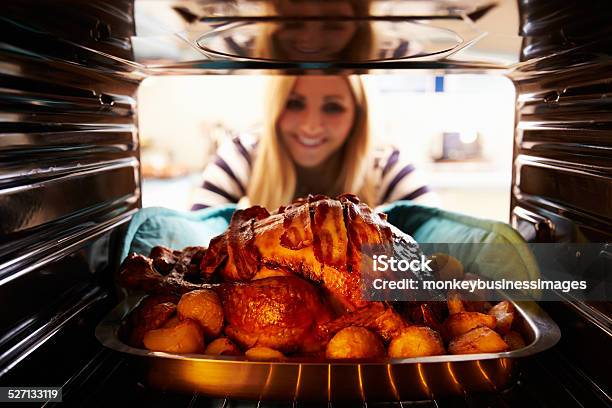 Woman Taking Roast Turkey Out Of The Oven Stock Photo - Download Image Now - Women, One Woman Only, Oven