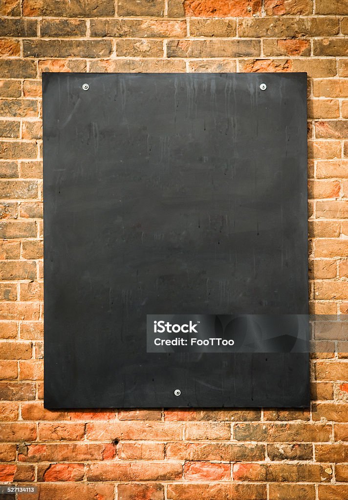 blank blackboard blank blackboard at a brick wall - nice background with space for text Announcement Message Stock Photo