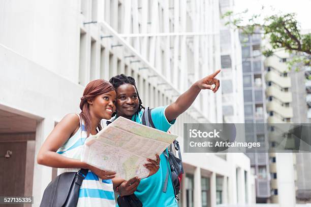 African Male Showing His Girlfriend Where Theyll Be Going Stock Photo - Download Image Now