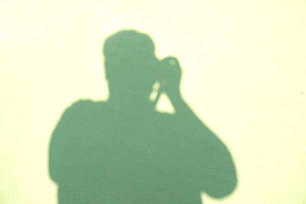 istock shadow of man take photo 527135509