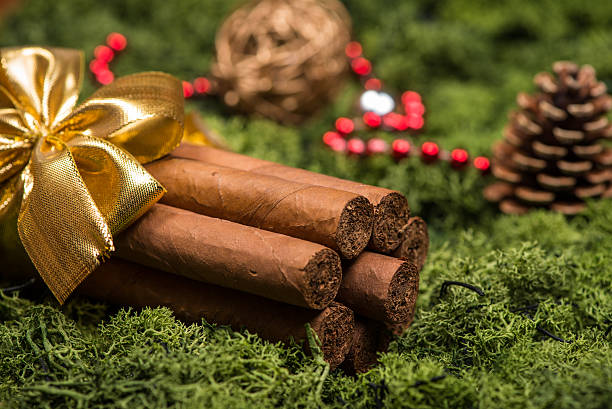 Cuban cigars Christmas gift with golden ribbon and ornaments stock photo