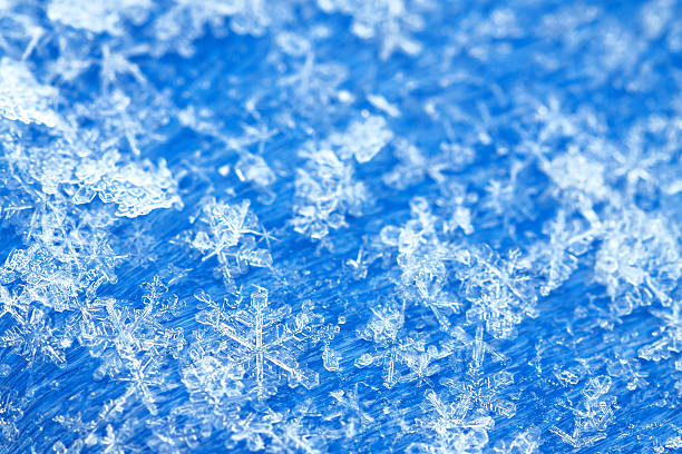 blue white winter background from snowflakes blur abstract blue white winter background from snowflakes blur icicle snowflake winter brilliant stock pictures, royalty-free photos & images