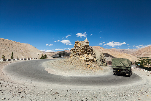 Road in Himalayas with army truck. Ladakh, India