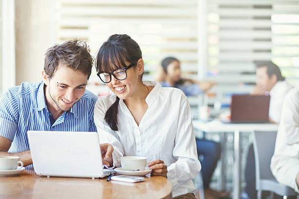 istock Man and woman using laptop and laughing 527139545