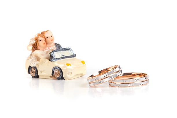 istock Wedding rings with toy machine isolation on a white background 527139941