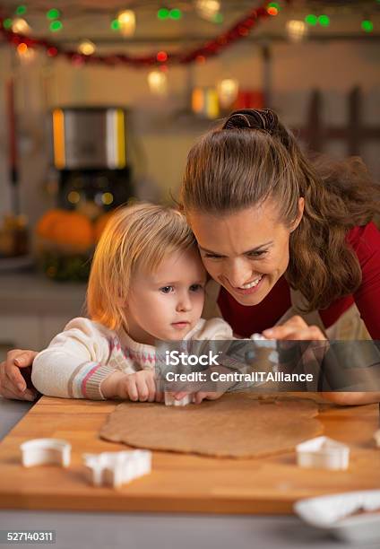 Portrait Of Mother And Baby Making Christmas Cookies Stock Photo - Download Image Now